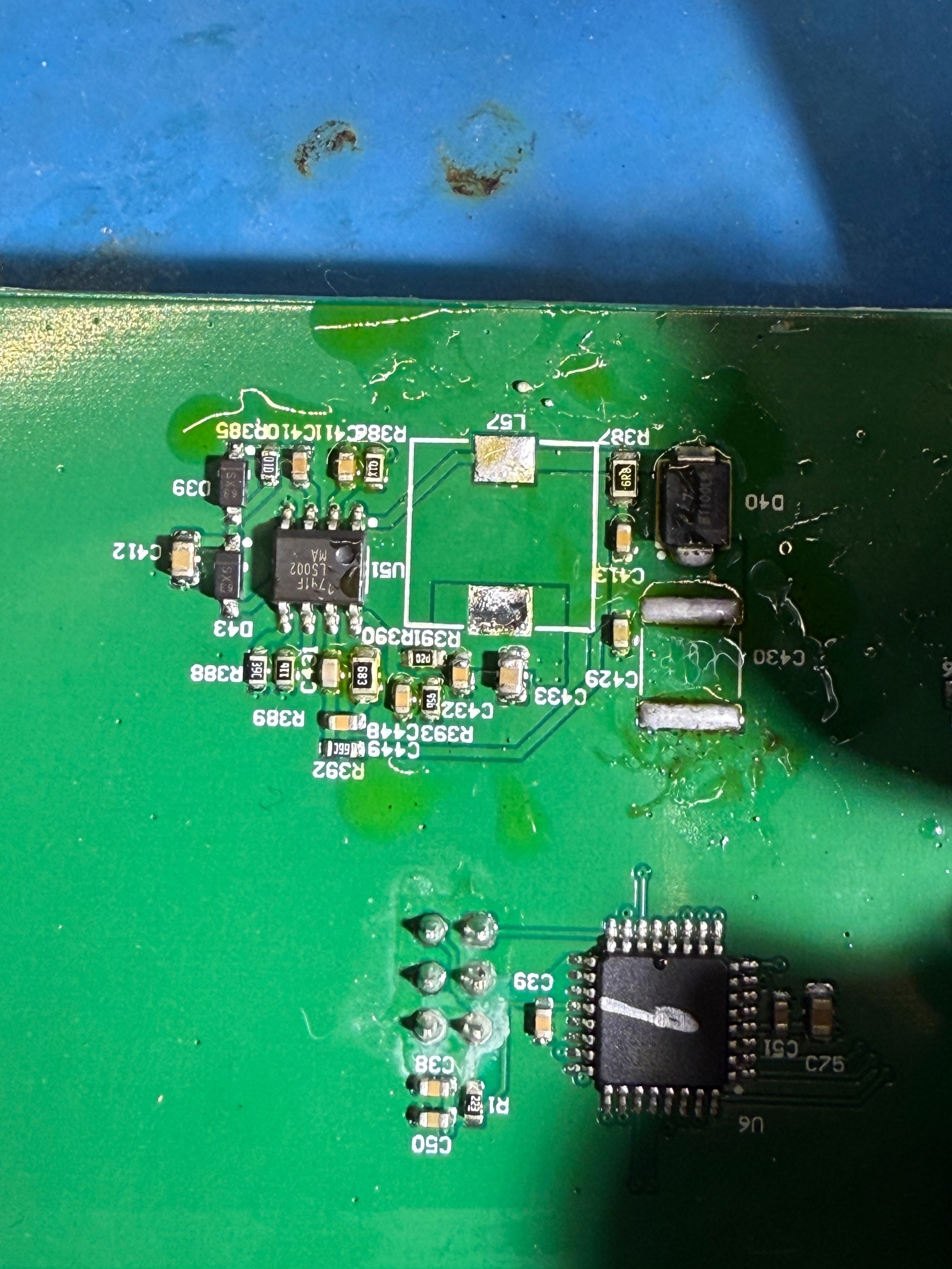Closeup of a PCB showing a switch mode circuit layout, with the inductor missing. Below is an Atmel Atmega 48P microcontroller.