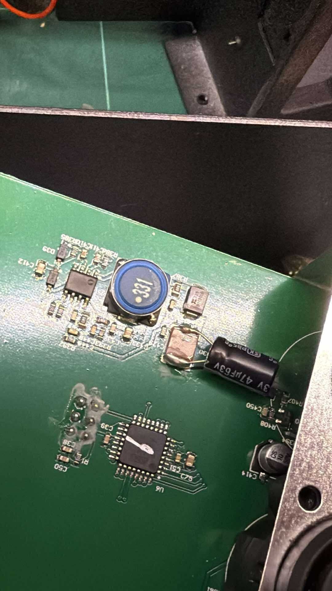 Photo showing the board section before inductor was removed, with an electrolytic cap bodged on top of a large ceramic cap.